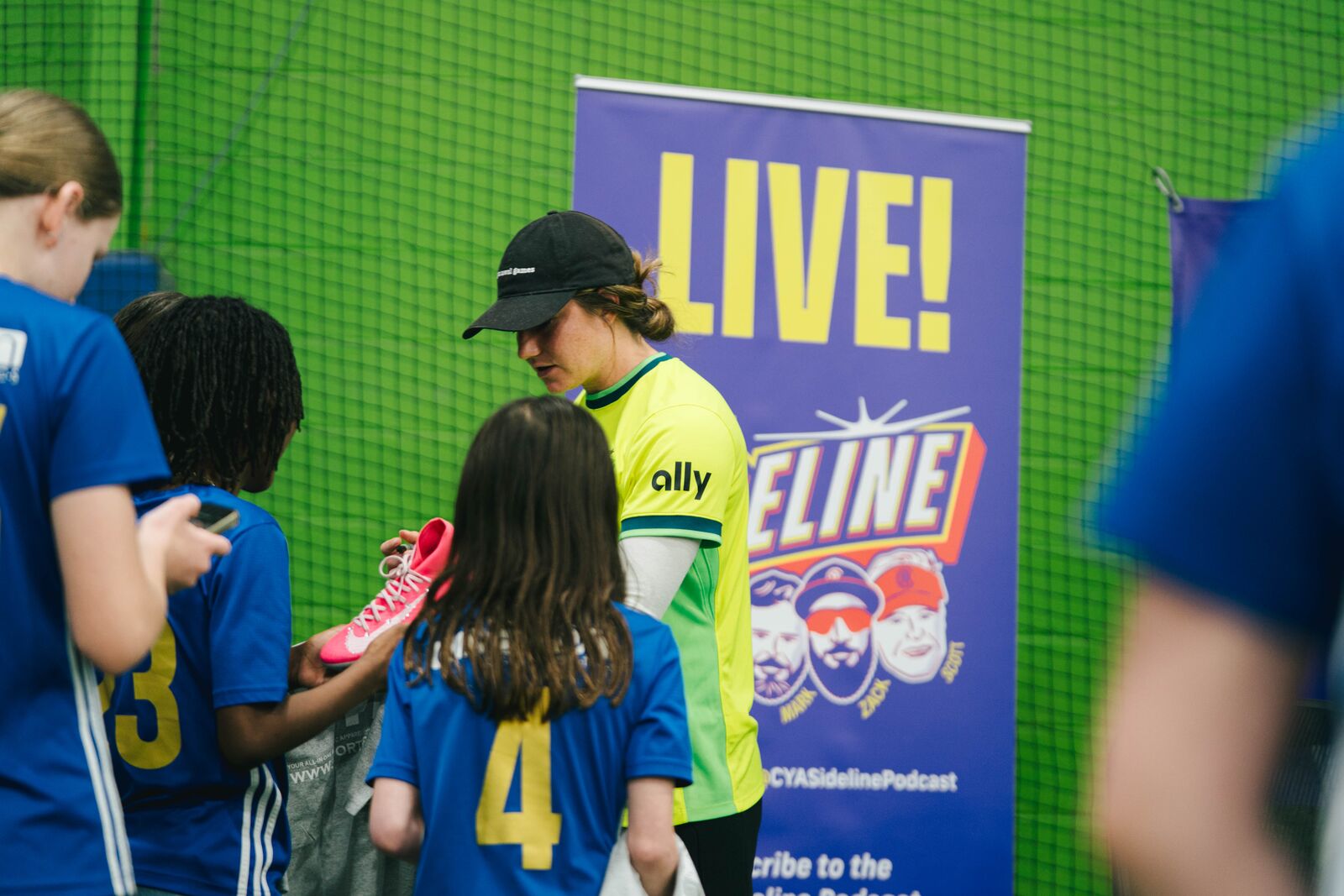 Kate Wiesner talking with young players while signing an autograph after the event.